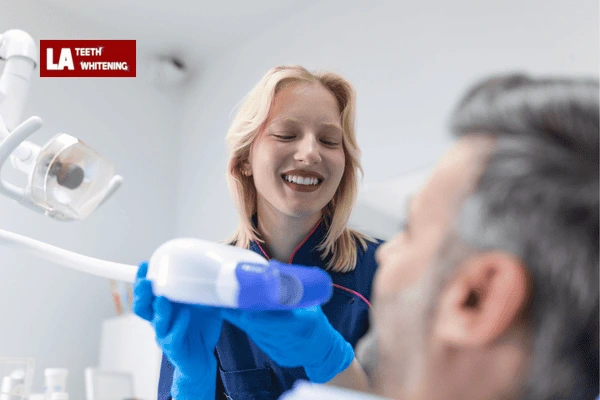 Dentist performing lazer whitening on a patient to remove extrinsic stains Hemel-Hempstead